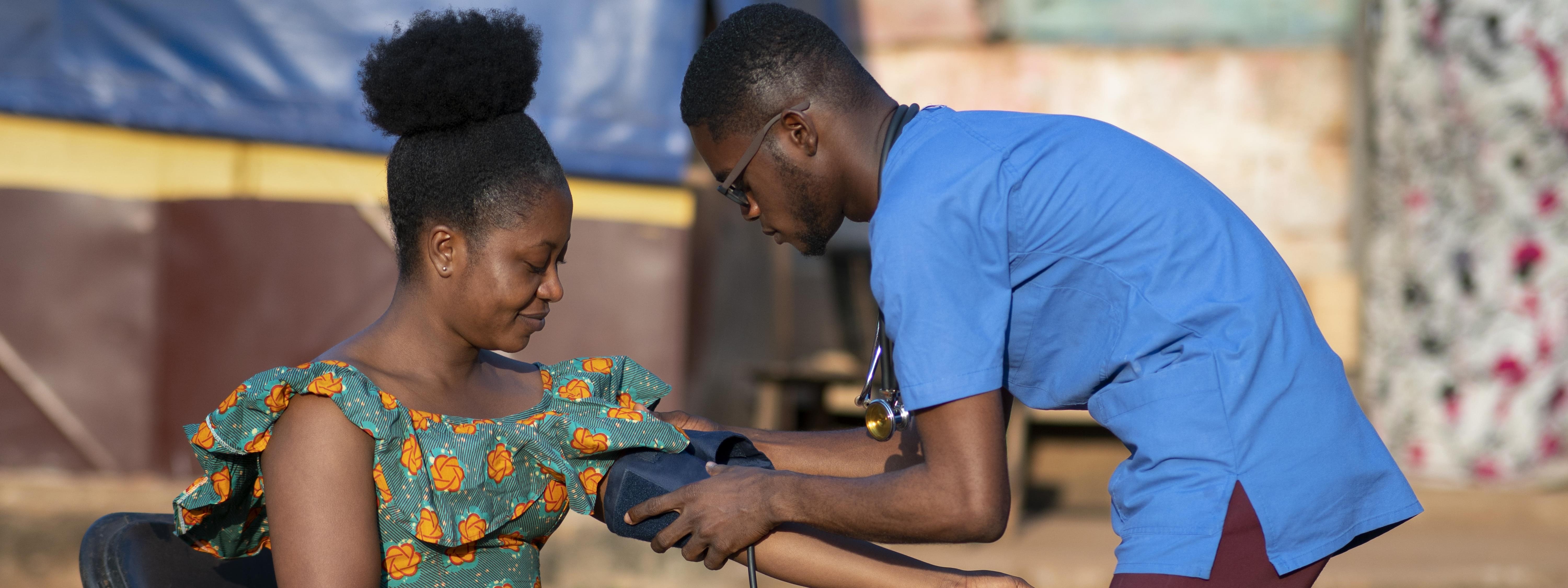 A healthcare worker attending to a patient during a community outreach screening